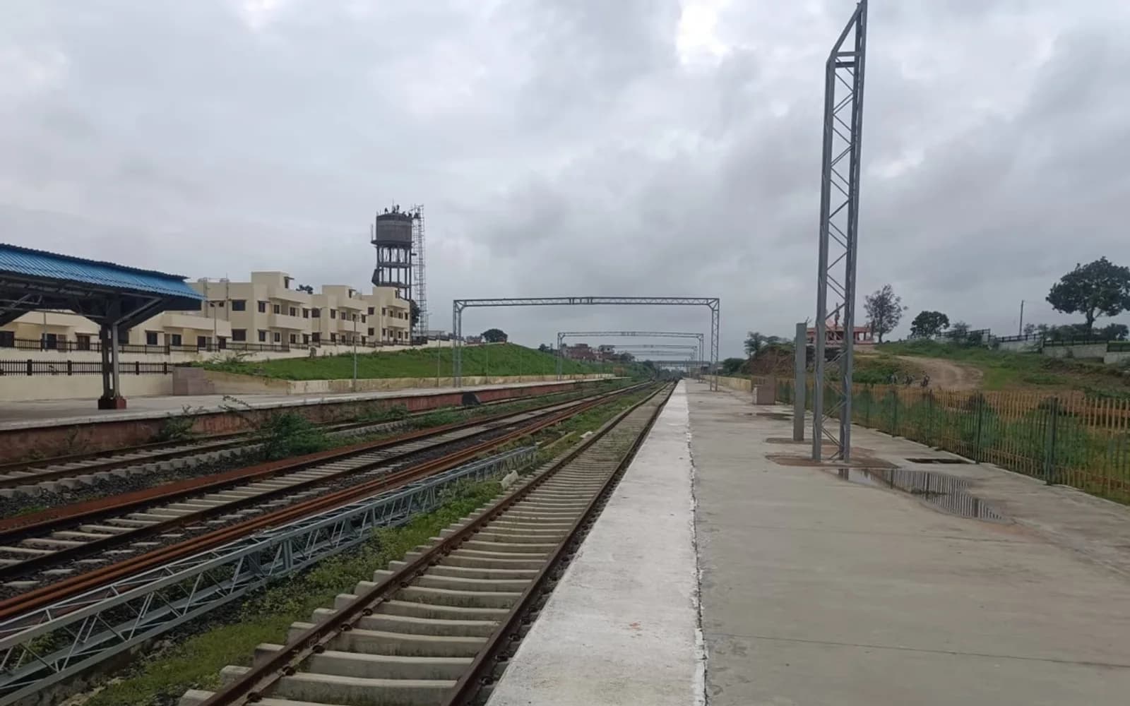 Urban railway corridor with new track and platform infrastructure in Maharashtra.